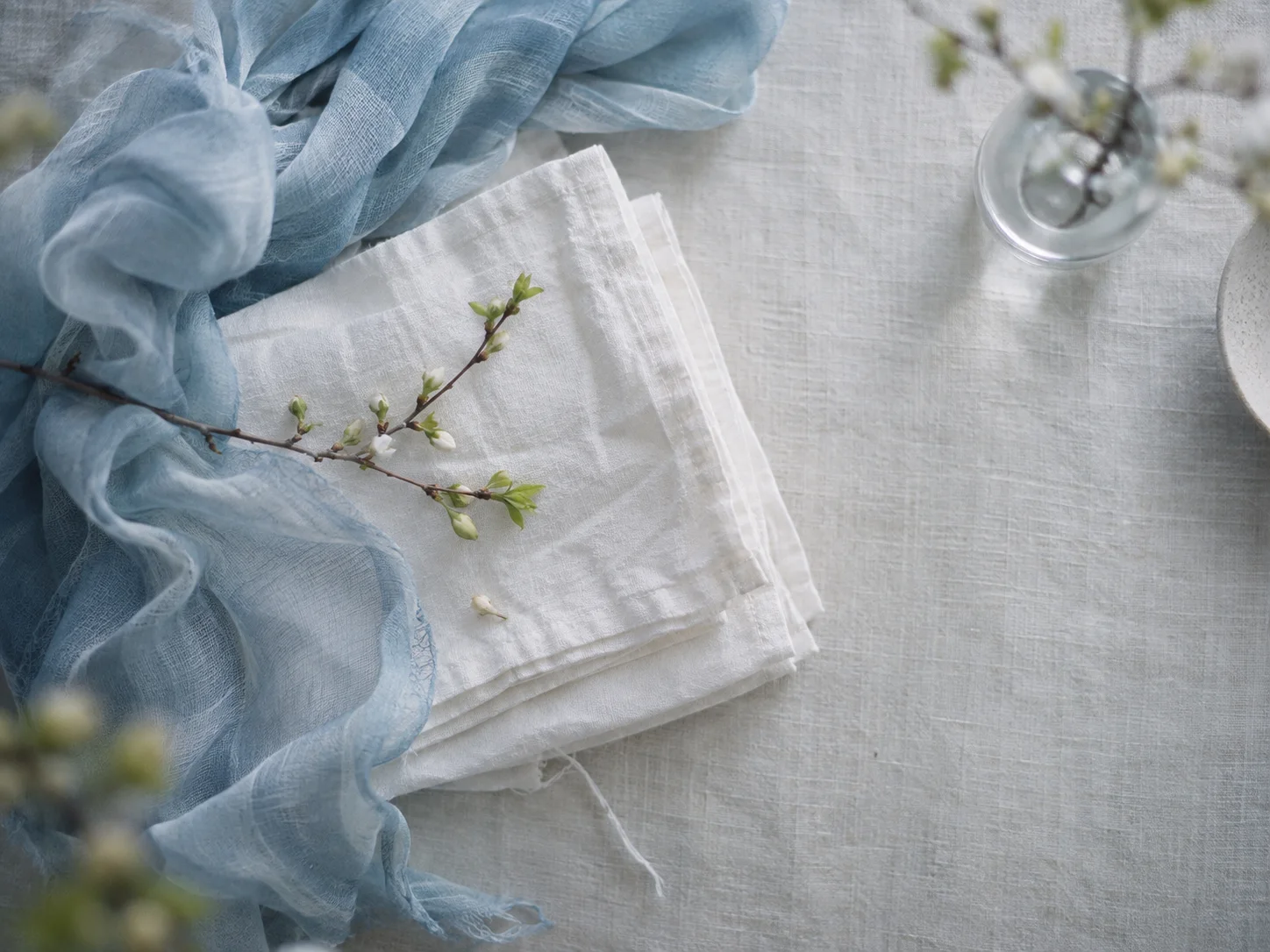 Folded White Linen and Pale Blue Scarf — AI-generated photograph