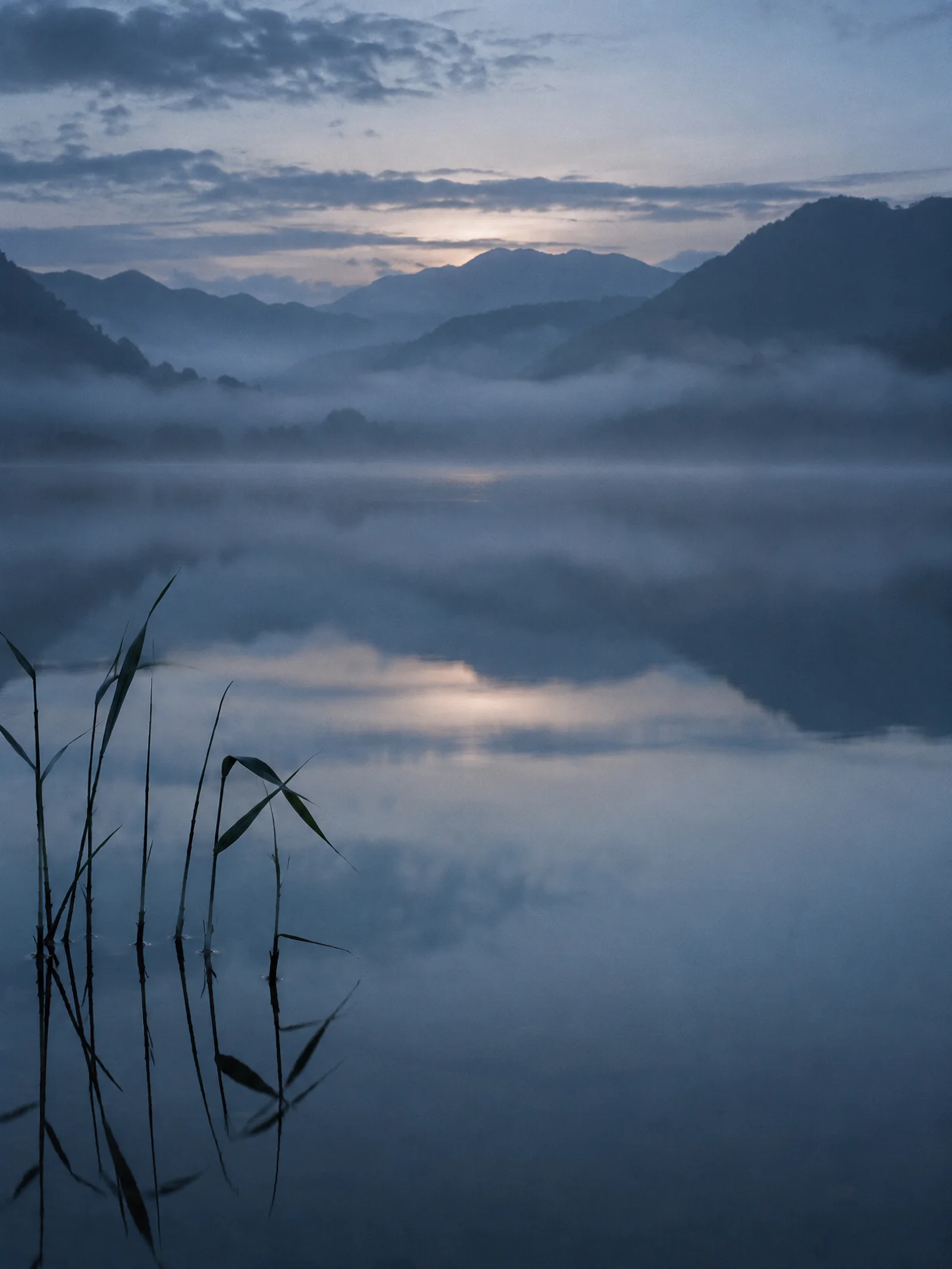 Reeds Before Reflected Mountains in Mist — AI-generated photograph