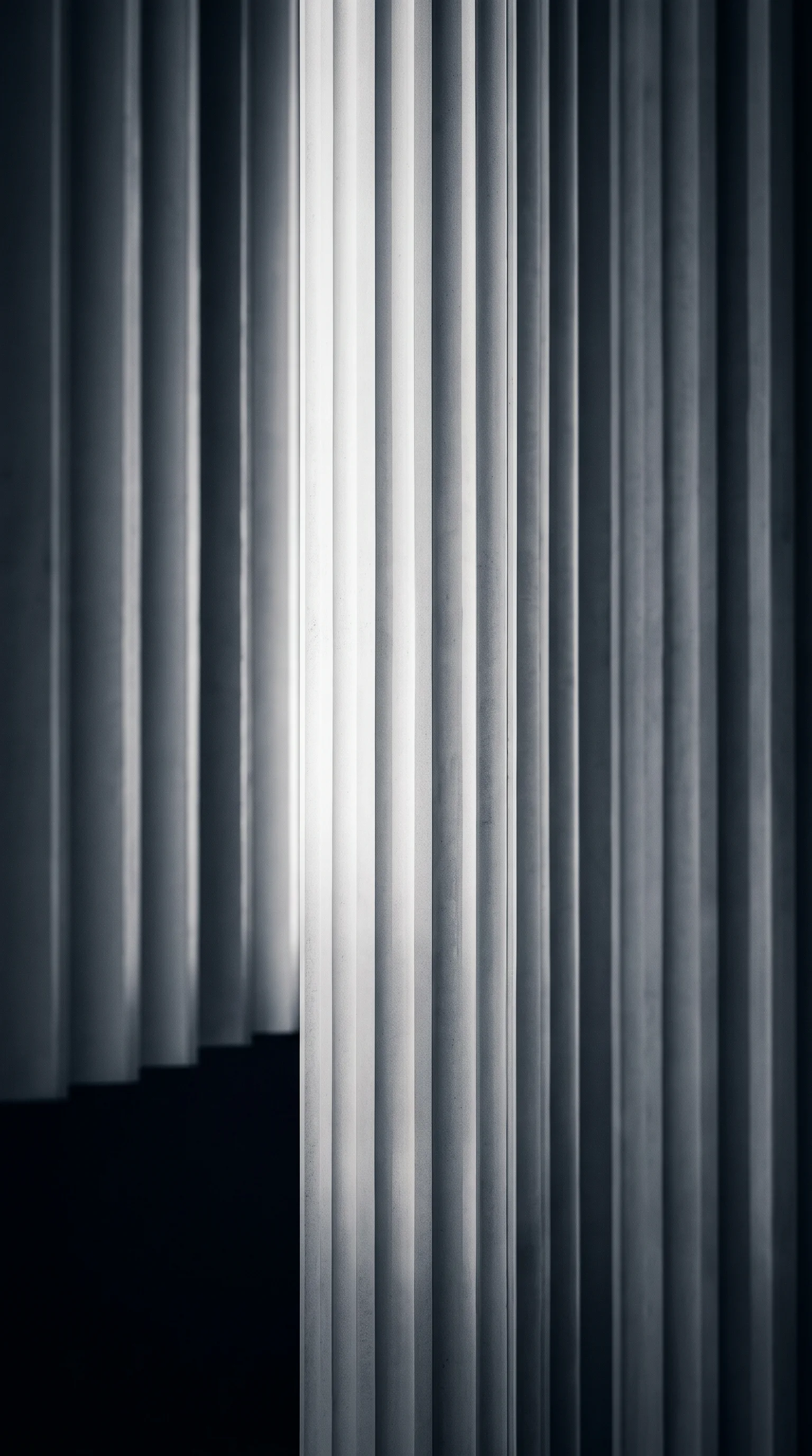 Fluted Concrete Columns in Selenium Monochrome — AI-generated photograph