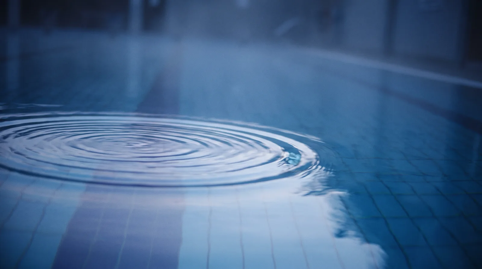 Concentric Ripple on a Still Blue Pool — AI-generated photograph