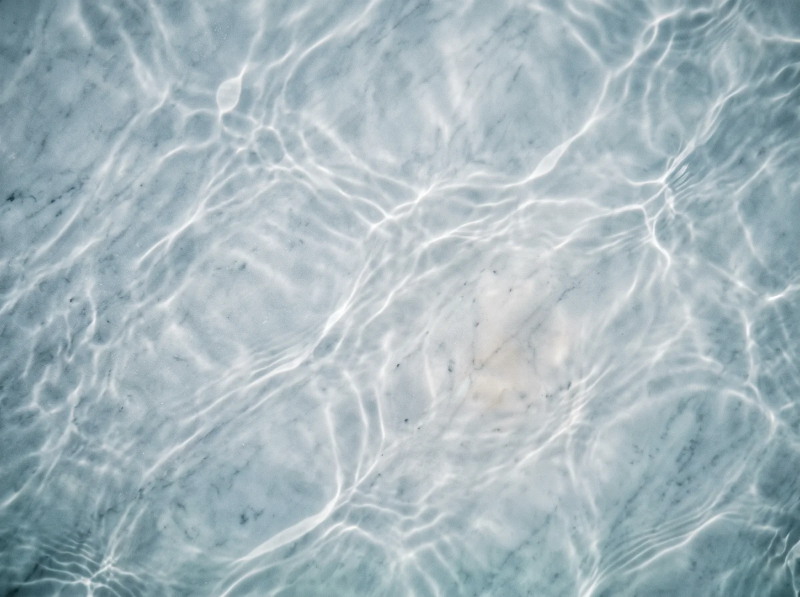 Caustic Light Net over Pale Blue Stone — AI-generated photograph