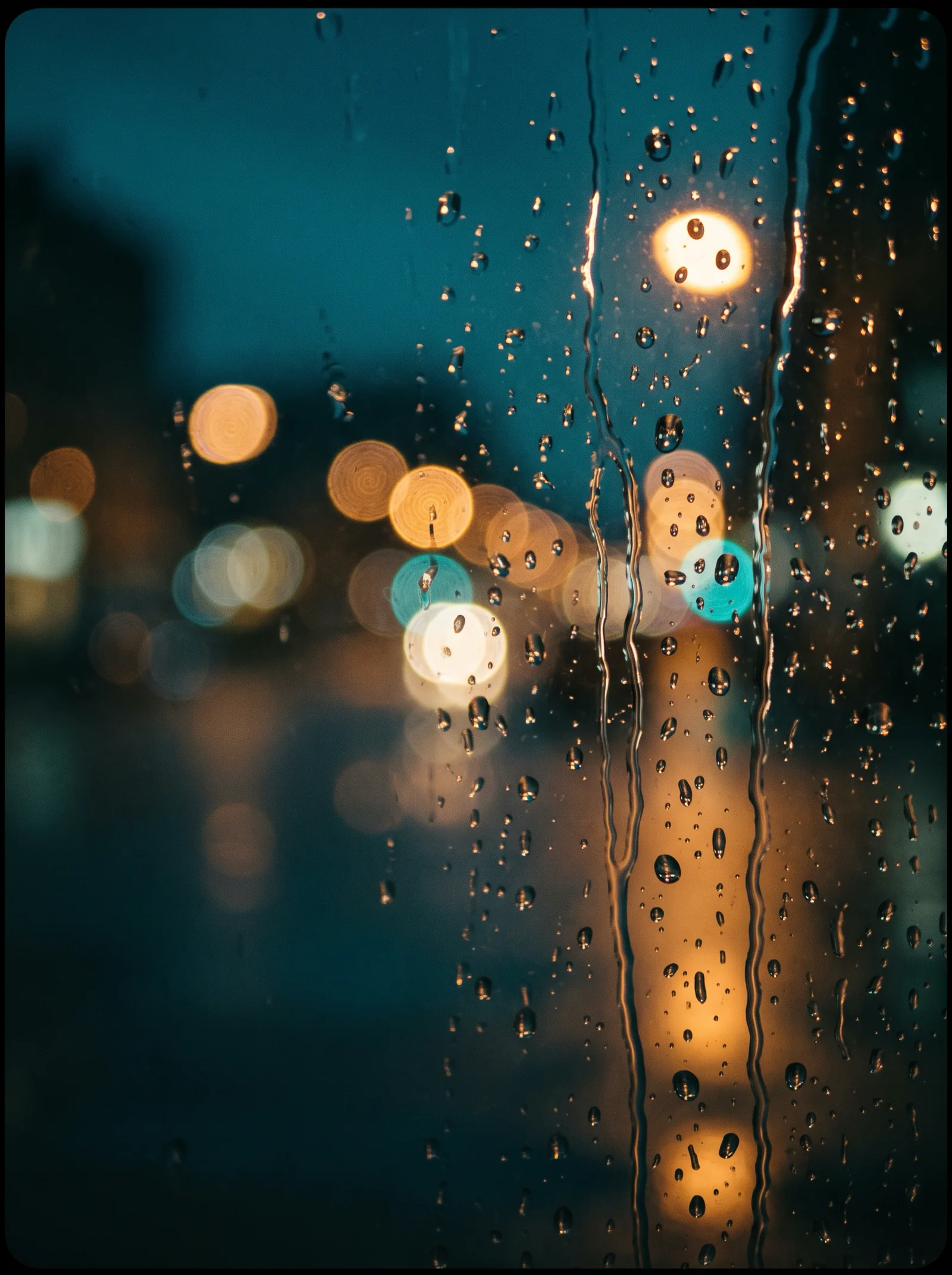 Teal and Amber Bokeh on Rainy Night Glass — AI-generated photograph