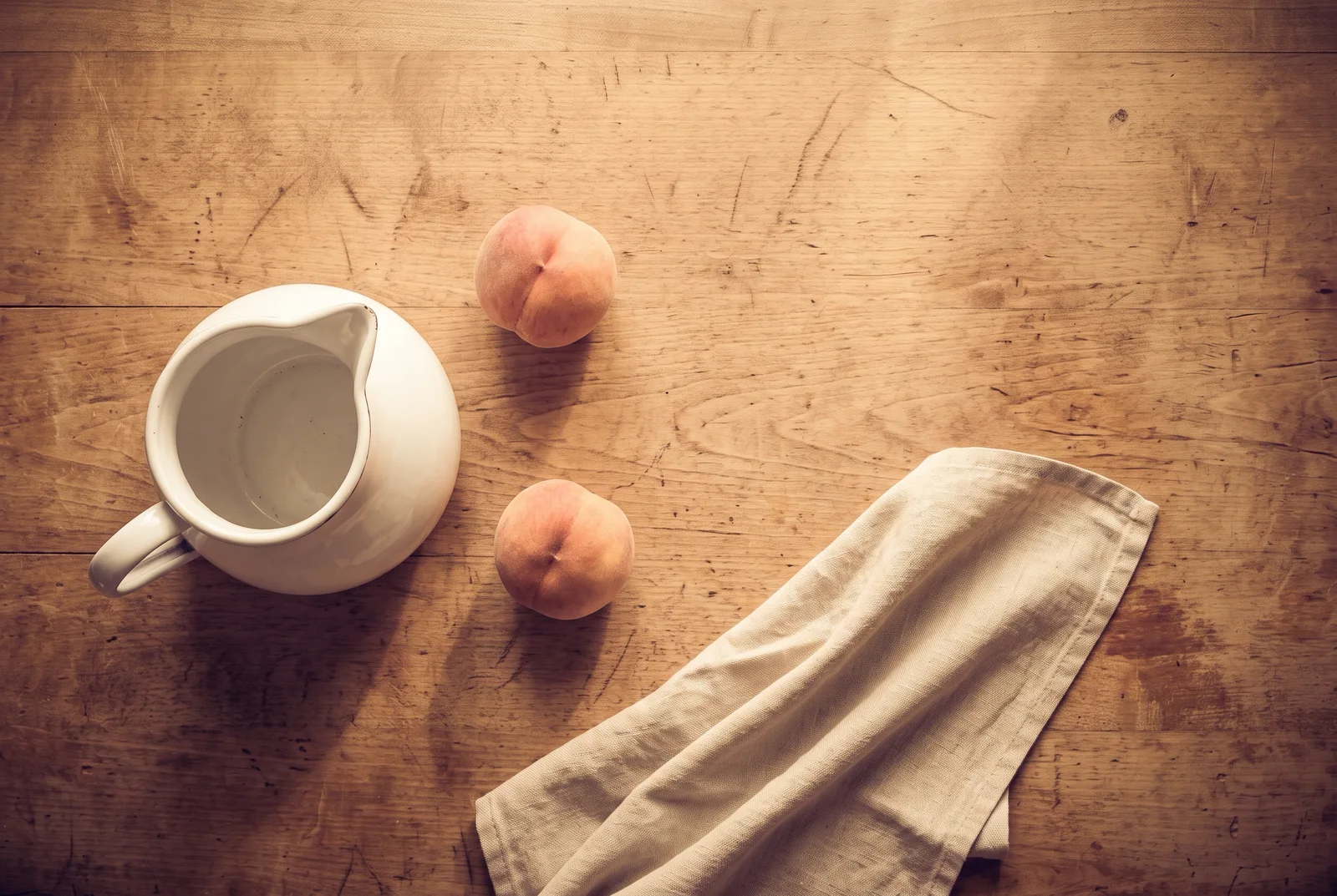 Peaches and Enamel Pitcher on Wooden Table — AI-generated photograph