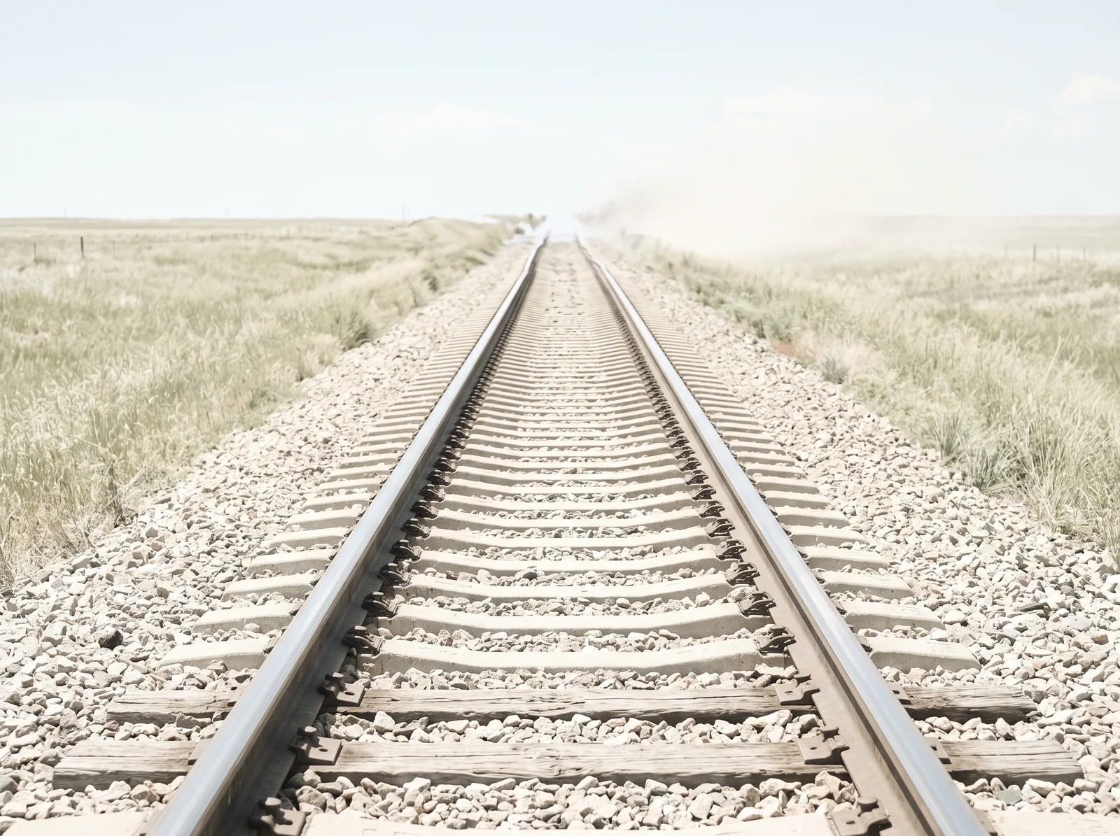 Single Railway Track Shimmering Under Noon Heat — AI-generated photograph