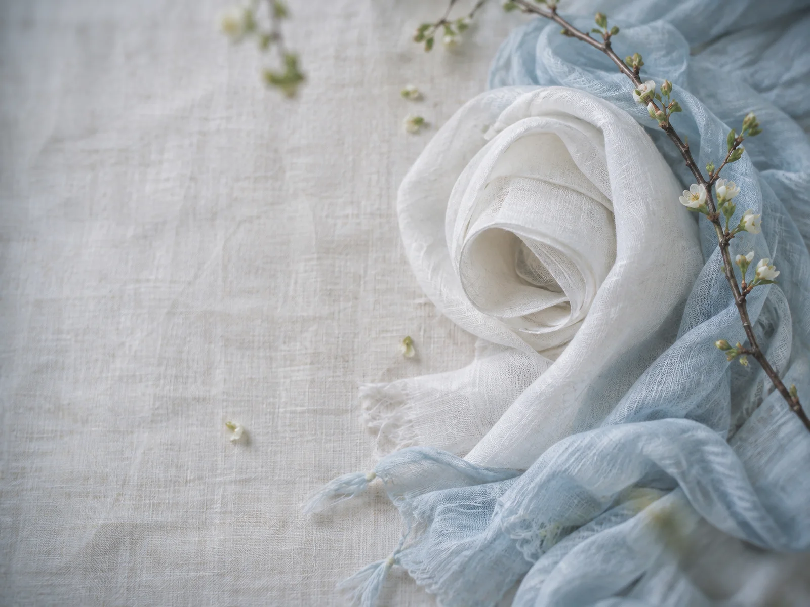 Rolled White Linen Beside a Blue Scarf — AI-generated photograph