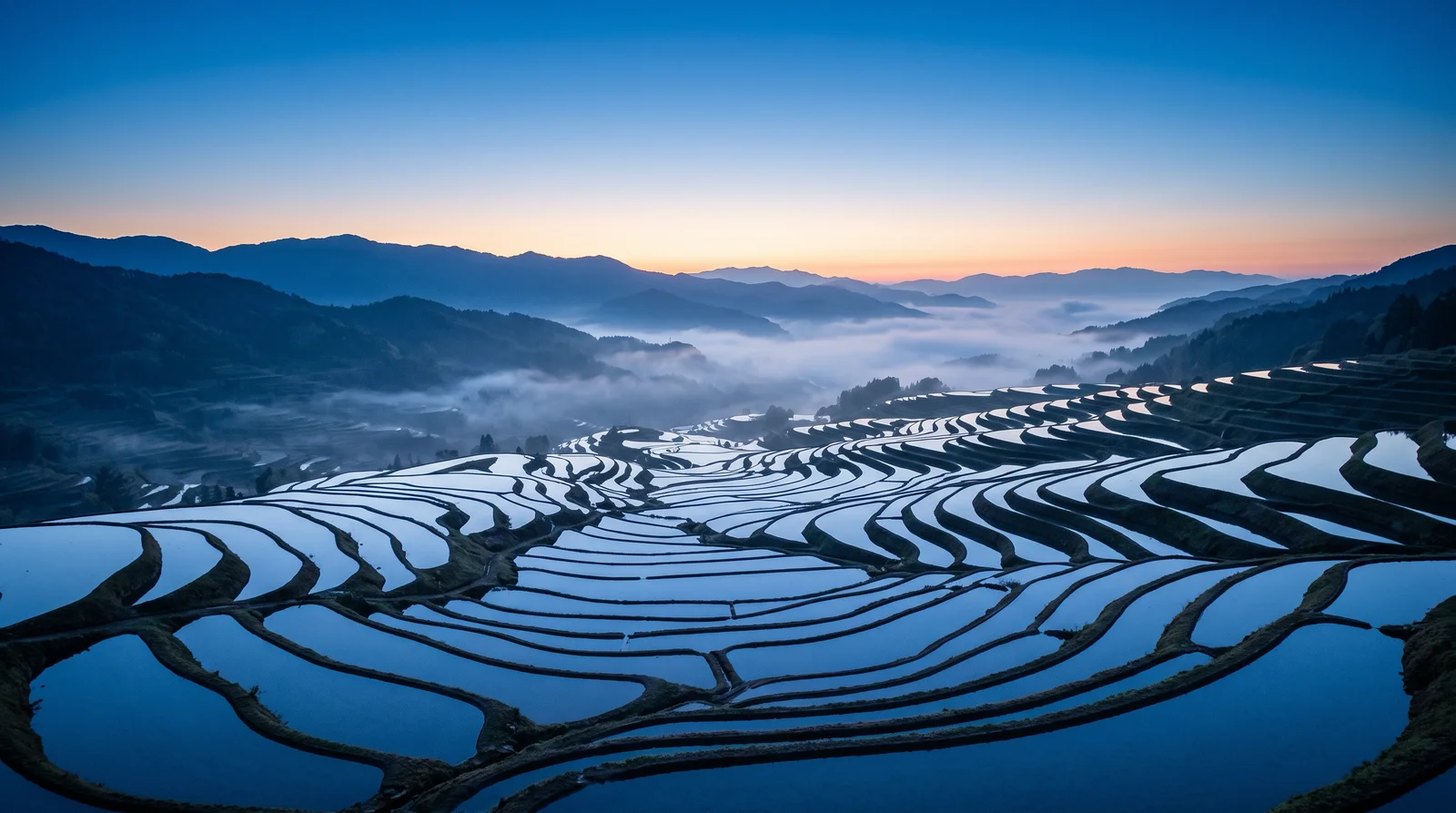 Misty Terraced Rice Fields Before Sunrise — AI-generated photograph