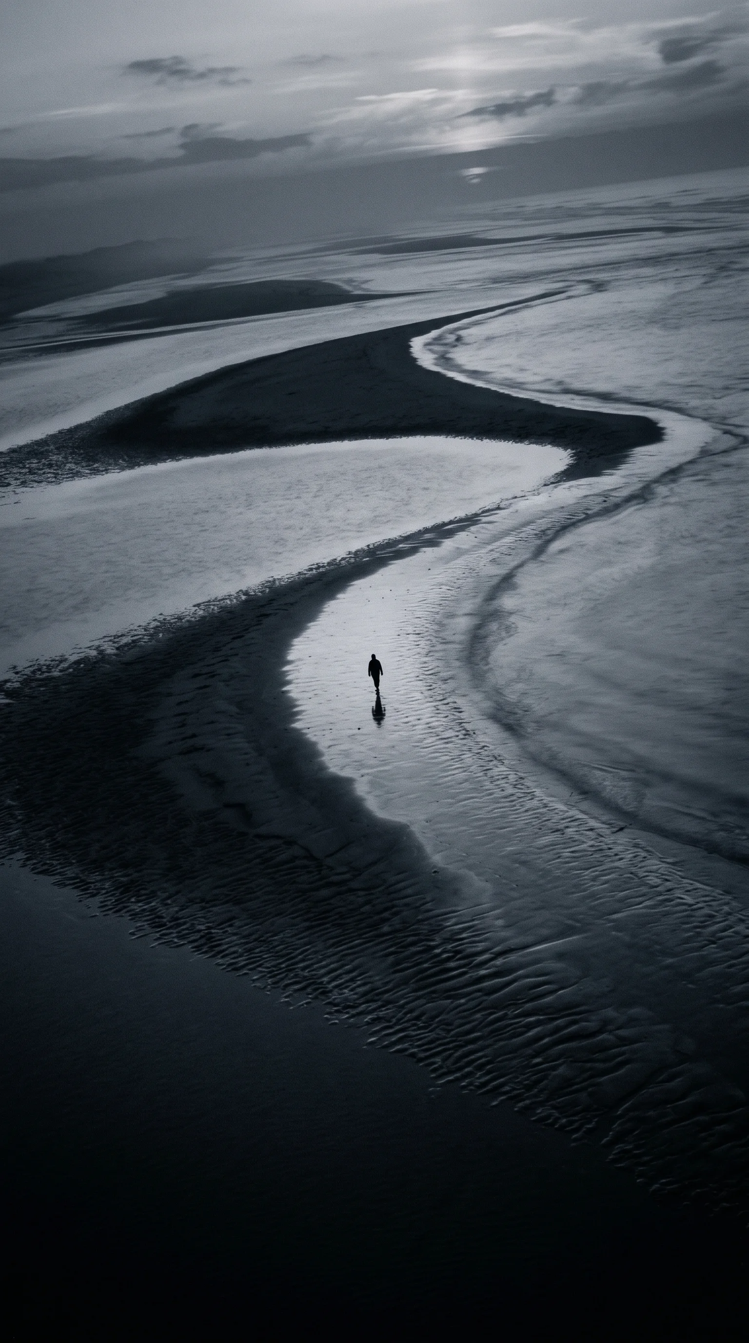 Tiny Figure on Wet Tidal Sand Ridges in Monochrome — AI-generated photograph