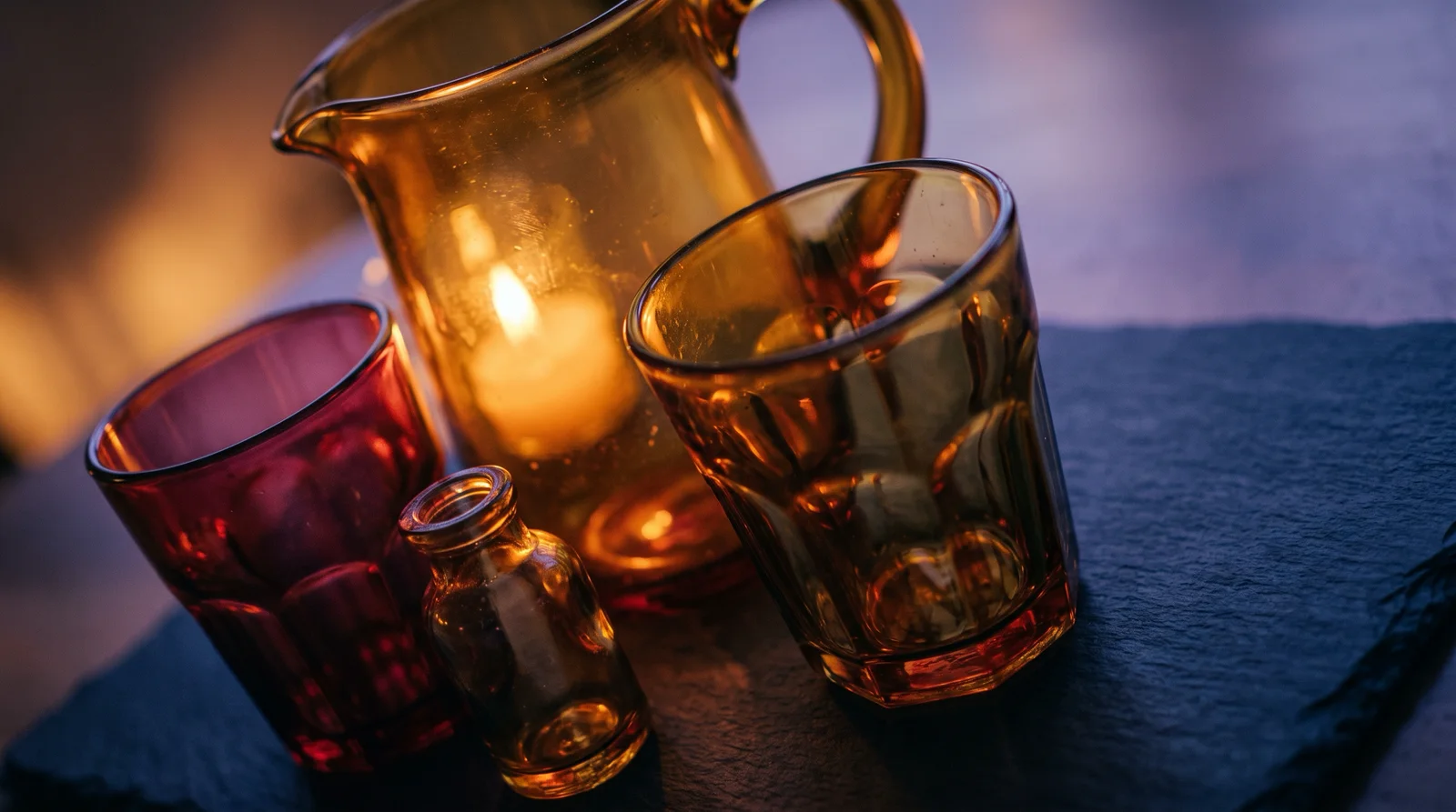 Candlelit Colored Glass Vessels With Violet Shadows — AI-generated photograph