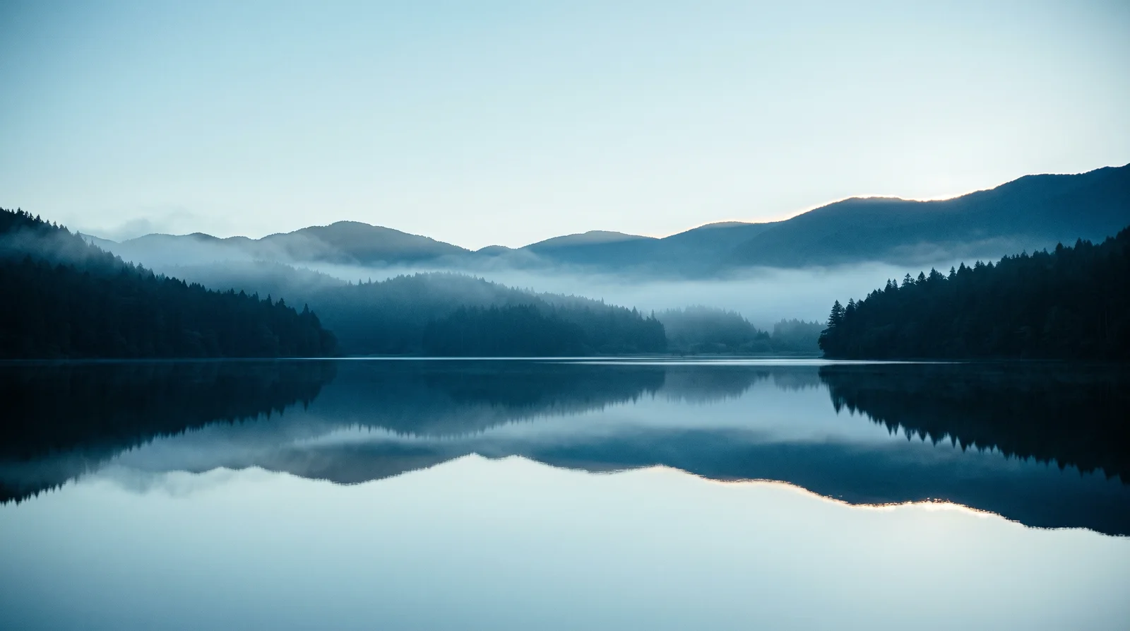 Layered Conifer Ridges Mirrored at First Light — AI-generated photograph