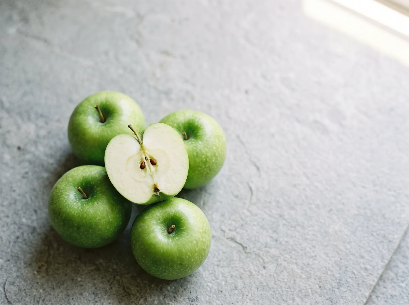Overhead Green Apples on a Grey Stone Slab — AI-generated photograph