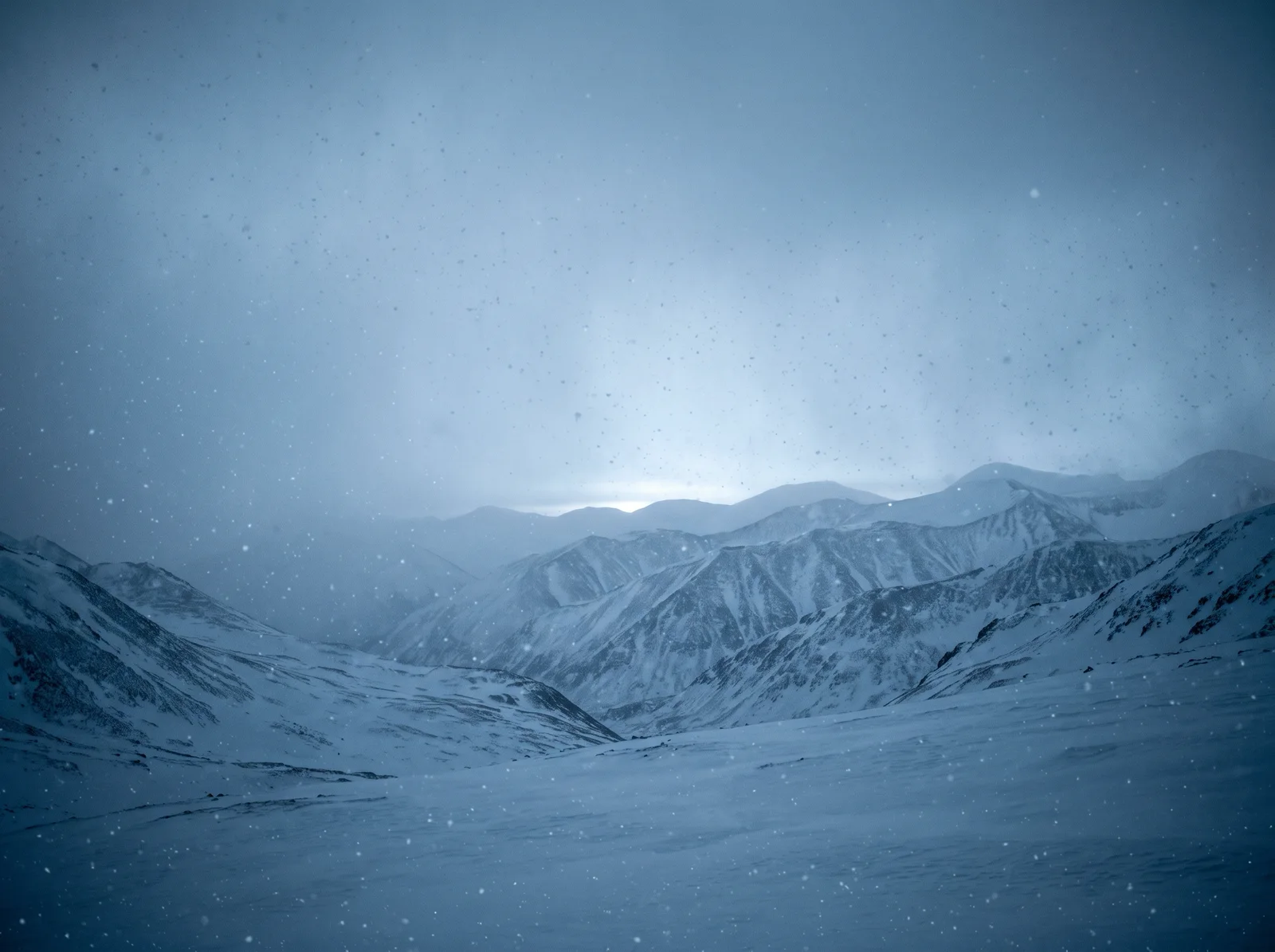 Snow Falling Over Misty Layered Ridges — AI-generated photograph