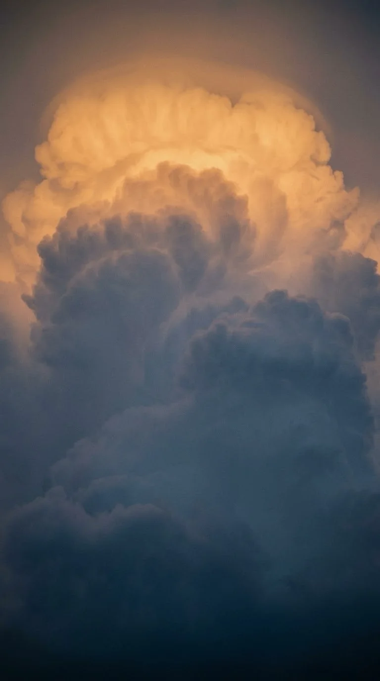 Sunlit Cumulonimbus Tower Against a Blue Gradient — AI-generated photograph