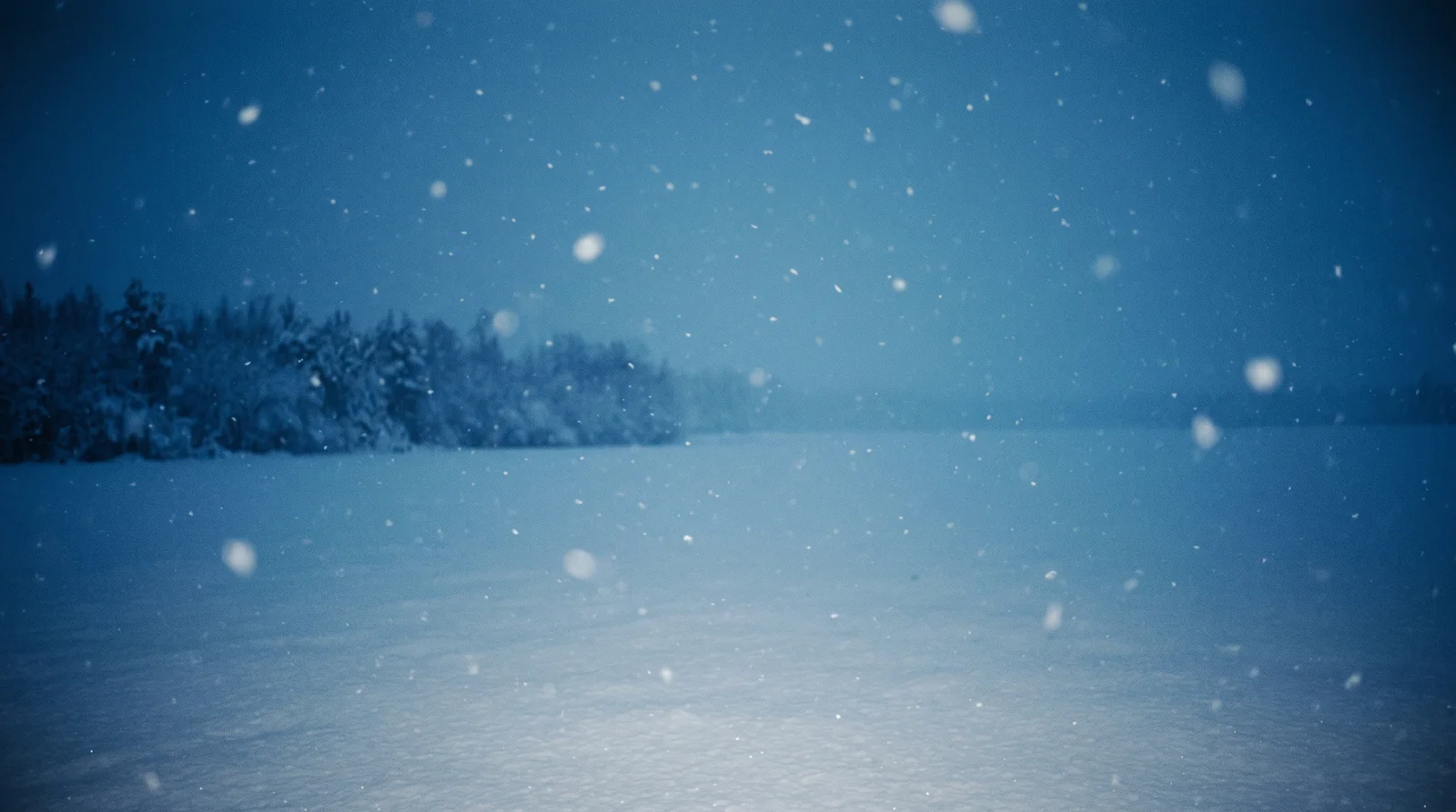 Snow Falling Over a Blue Snowfield at Night — AI-generated photograph
