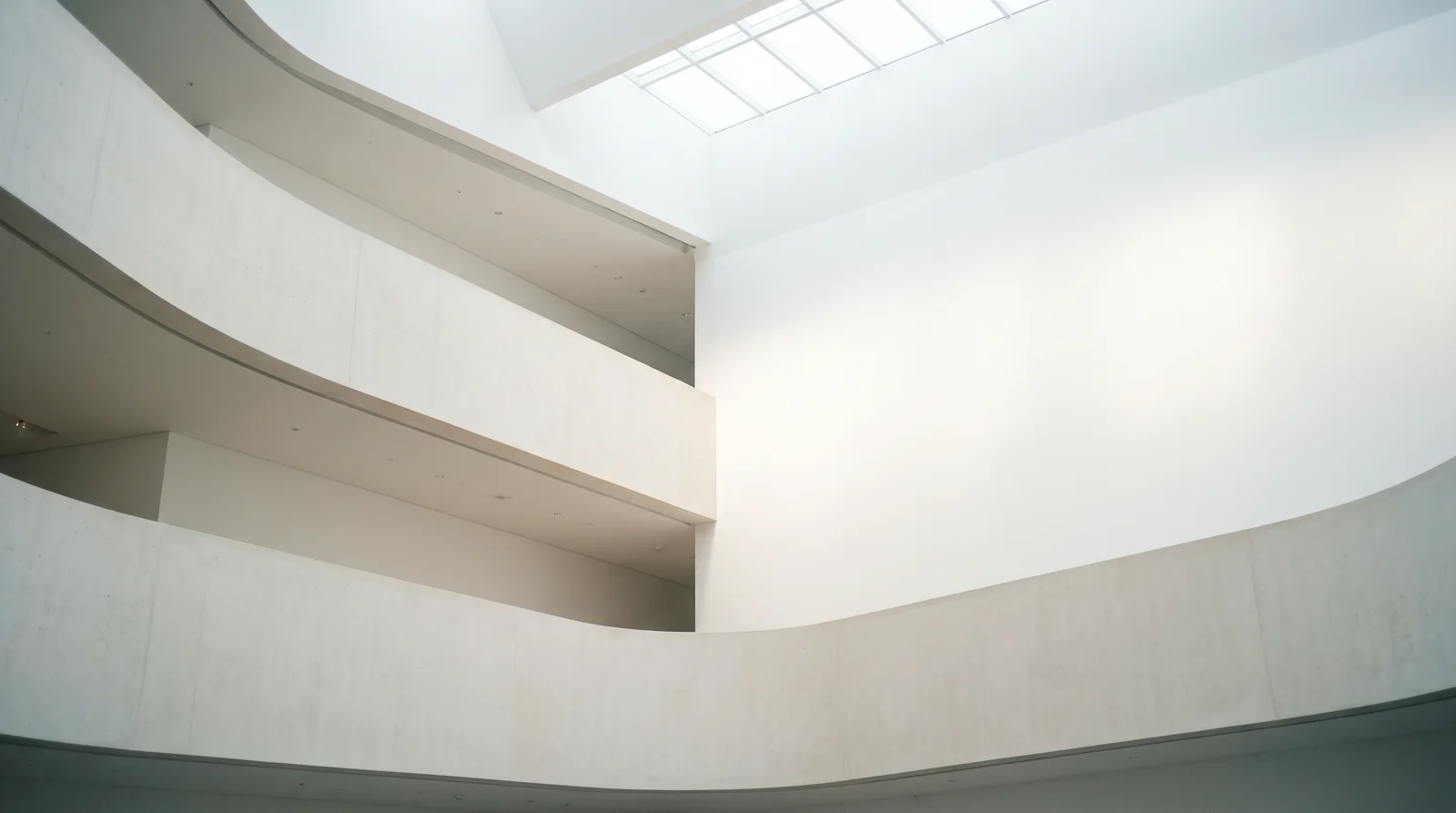 White Concrete Atrium Under a Skylight — AI-generated photograph