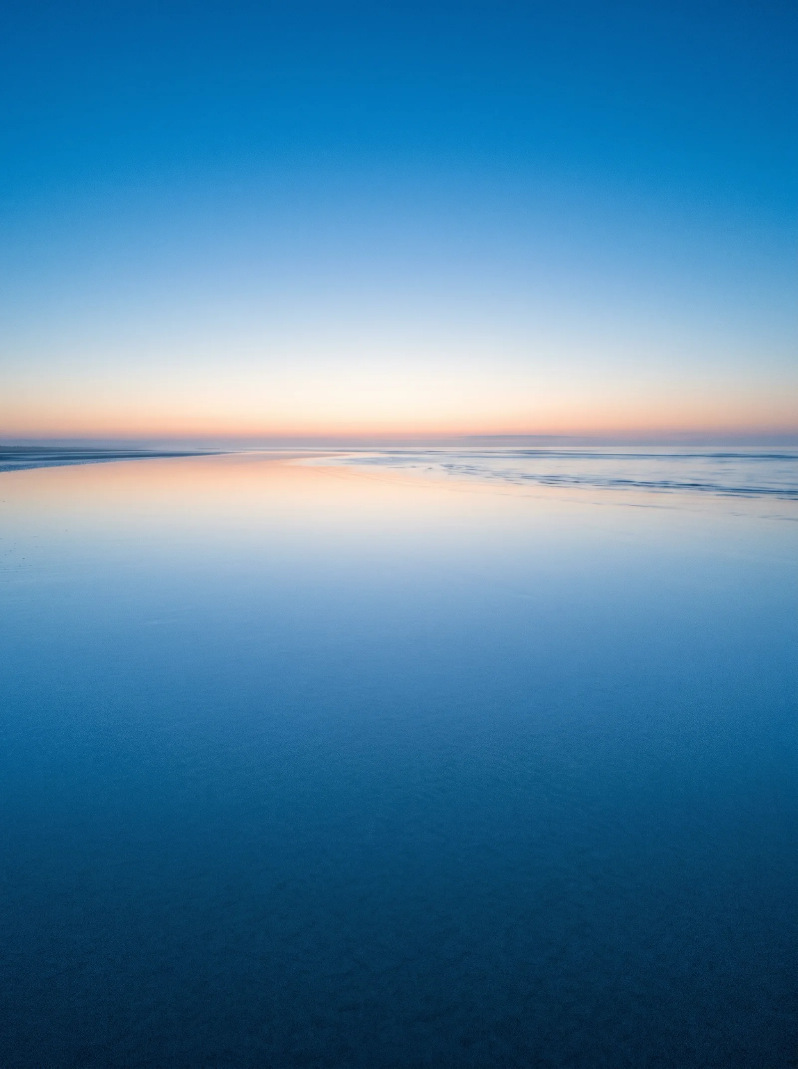 Distant Horizon Mirage on a Dawn Tidal Flat — AI-generated photograph