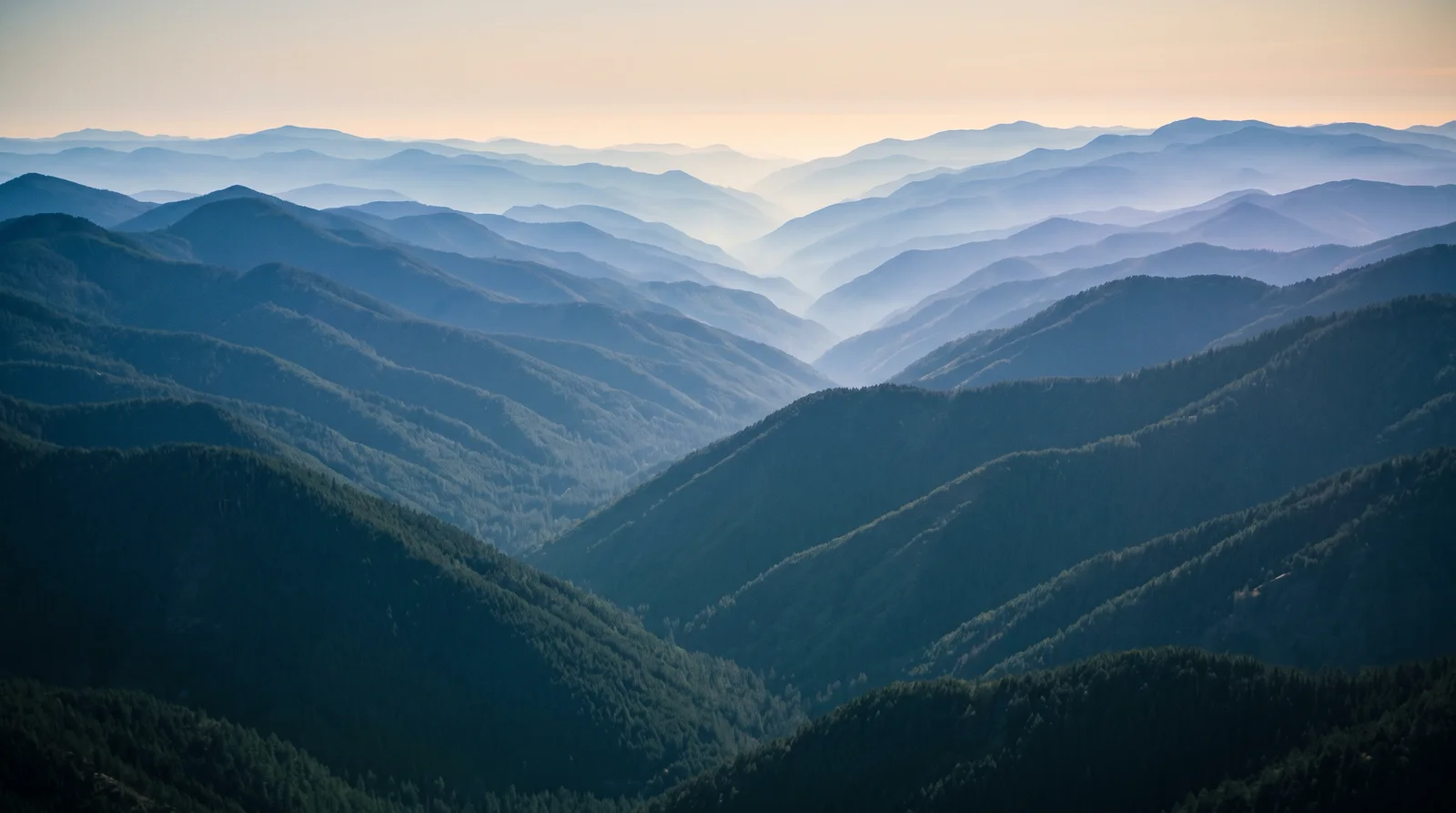 Layered Blue Mountain Ridges in Haze — AI-generated photograph