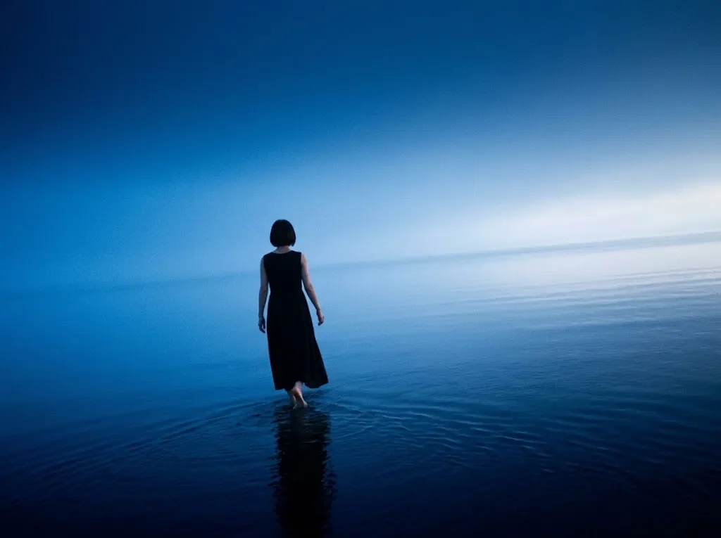 Woman Wading Toward a Dawn Horizon — AI-generated photograph