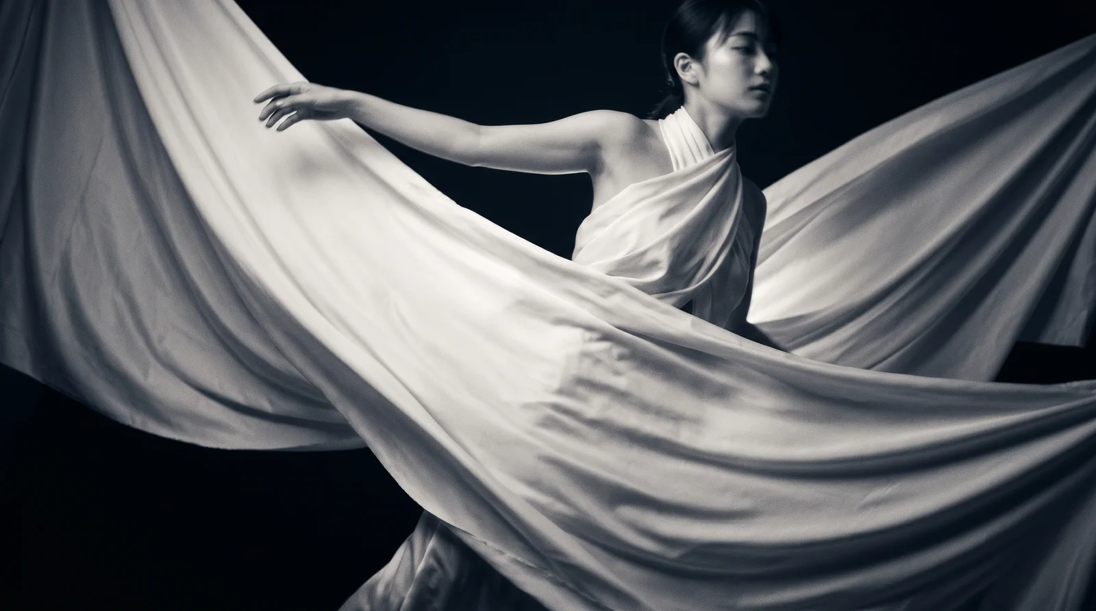Woman Swirling White Fabric in Monochrome — AI-generated photograph