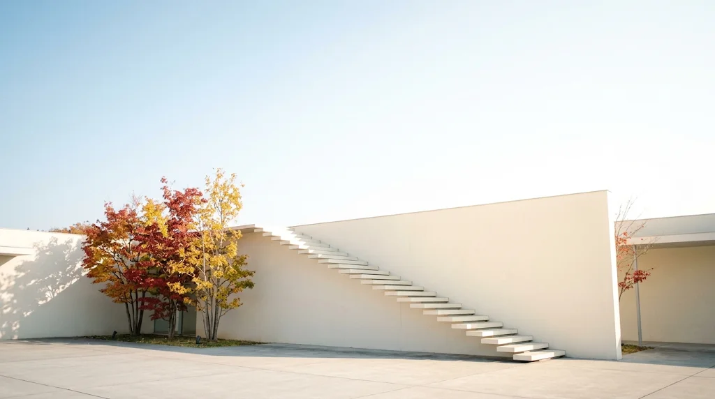 White Concrete Building With Autumn Trees Under a Pale Sky — AI-generated photograph