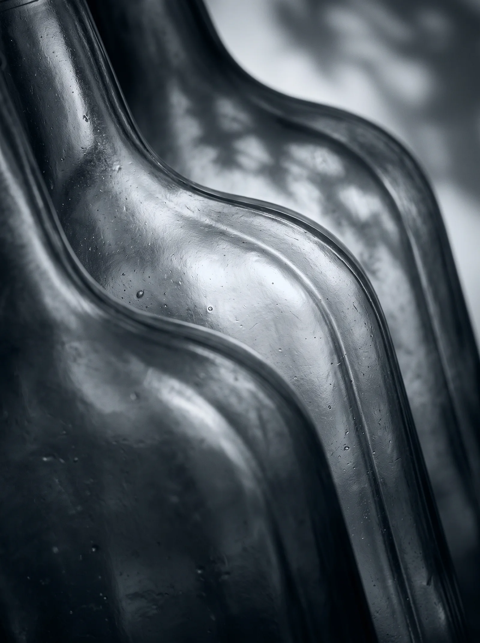 Backlit Glass Bottle Ridges in Silver Monochrome — AI-generated photograph