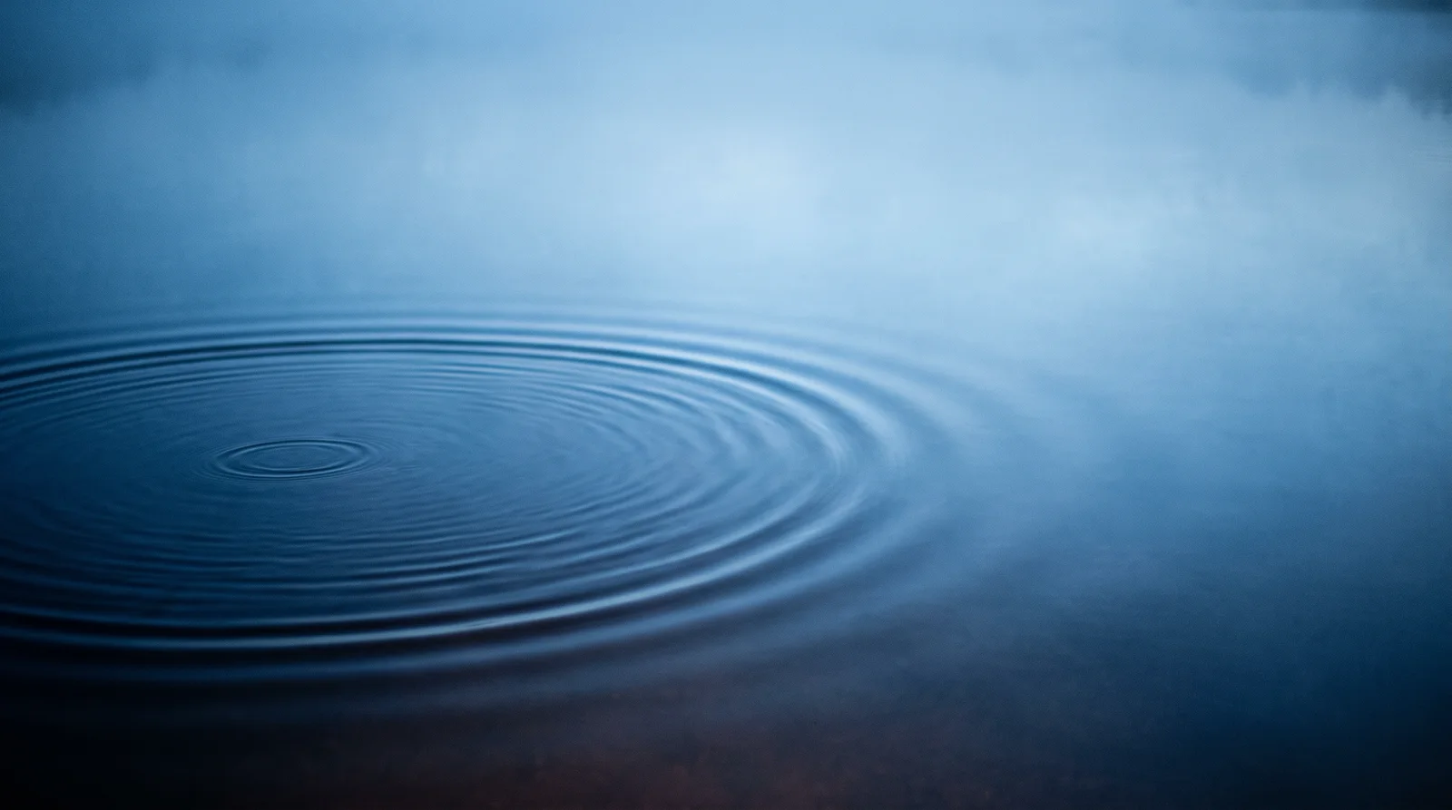 Blue Ripples Spreading on Still Water — AI-generated photograph