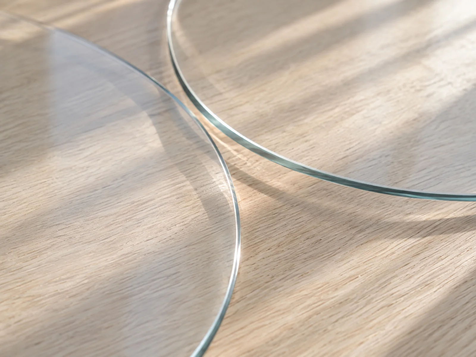 Overlapping Glass Discs on Pale Wood — AI-generated photograph