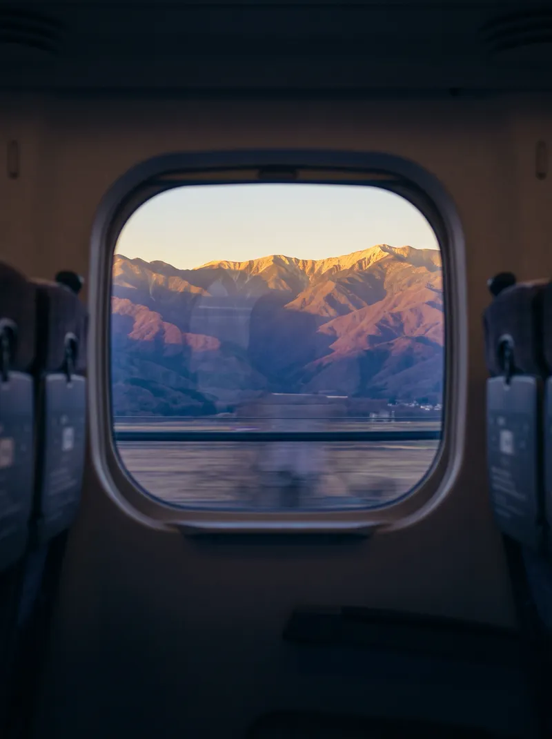 Golden Ridges Through a Shinkansen Window — AI-generated photograph