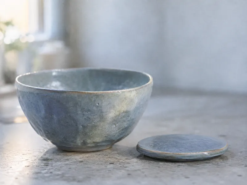 Blue Ceramic Bowl Beside a Flat Lid — AI-generated photograph