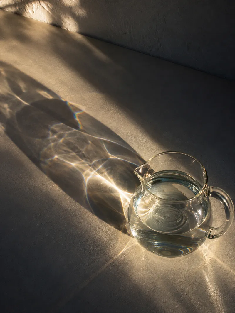 Water Pitcher With Ripples and Caustics — AI-generated photograph