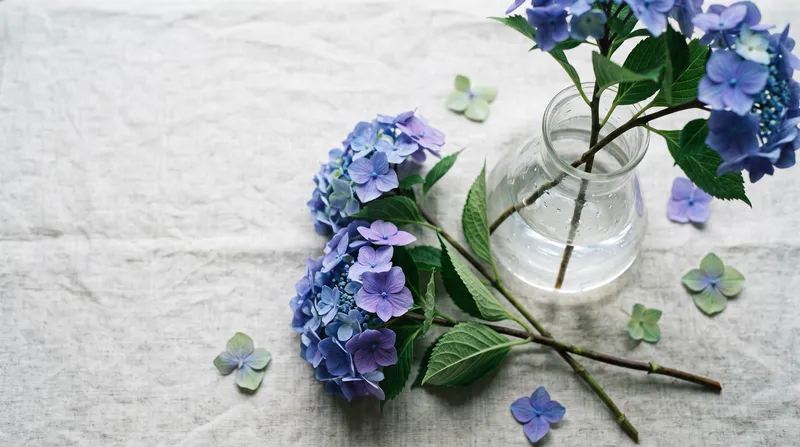 Cut Blue Hydrangea on Pale Linen, Overhead — AI-generated photograph