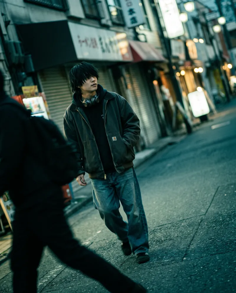 Man Walking Past Shuttered Shopfronts at Dusk — AI-generated photograph