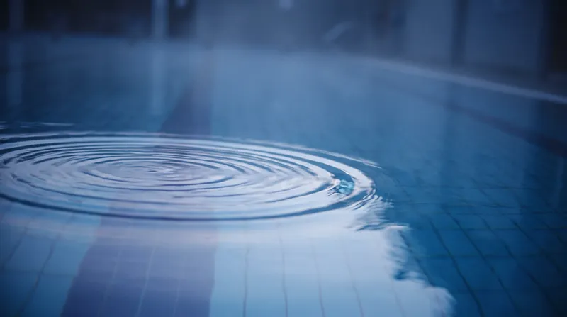 Concentric Ripple on a Still Blue Pool — AI-generated photograph