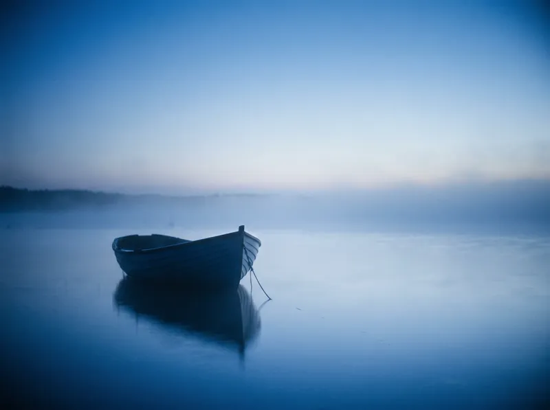 Moored Boat Silhouette in Blue Sea Fog — AI-generated photograph