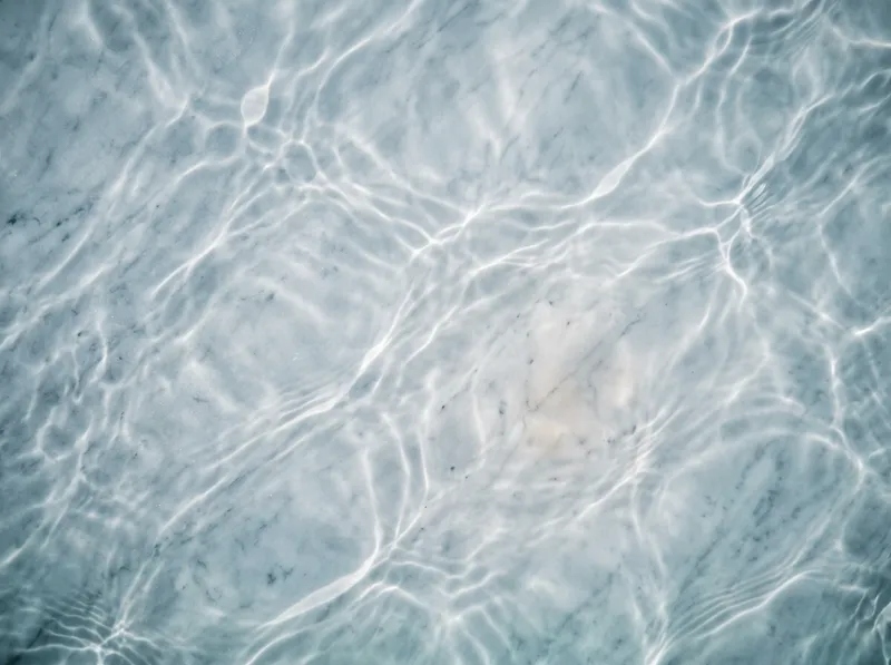 Caustic Light Net over Pale Blue Stone — AI-generated photograph