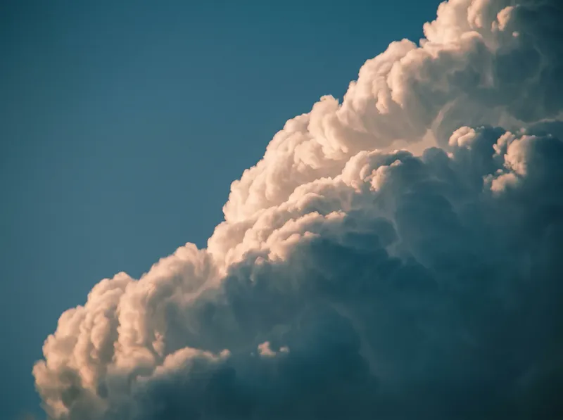 Sunlit Cumulus Against a Deep Blue Sky — AI-generated photograph