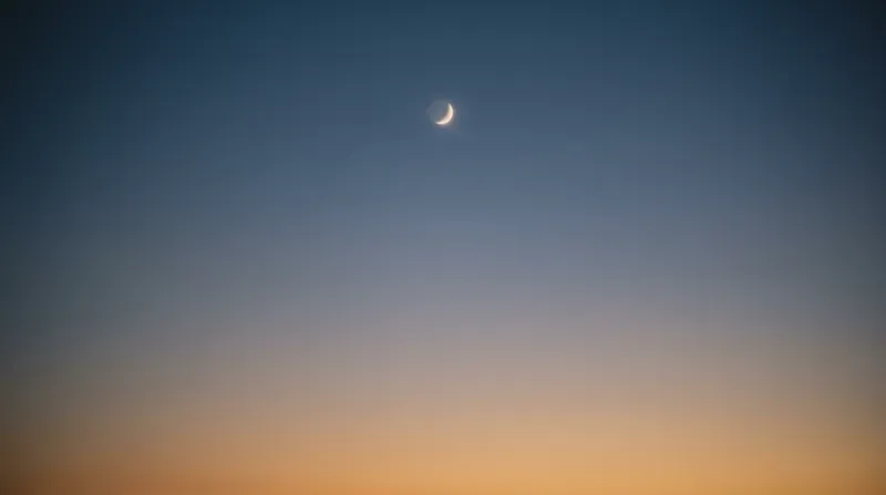 Pale Moon in an Amber-Blue Twilight Gradient — AI-generated photograph