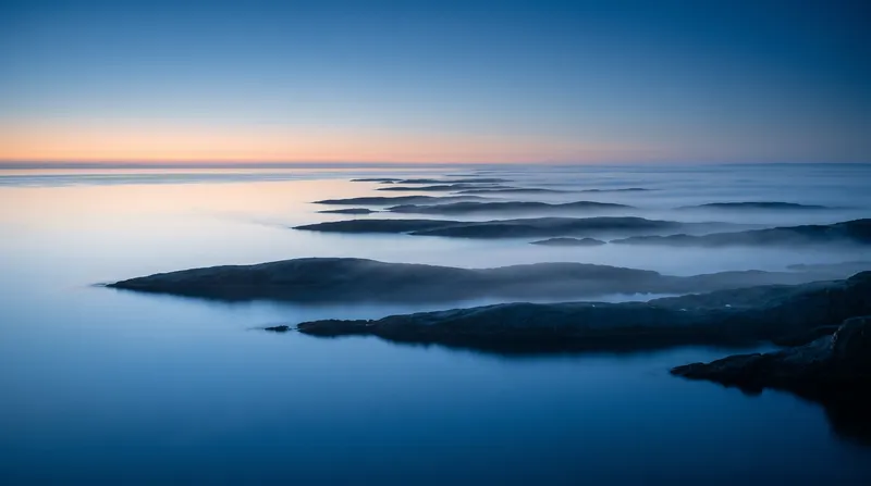 Sea Fog Drifting Over Coastal Rocks at Dawn — AI-generated photograph
