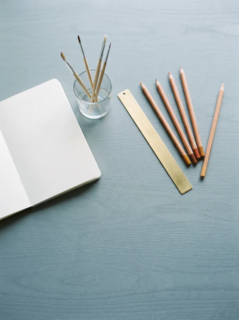 Top-Down Colored Pencils and Sketchbook — AI-generated photograph