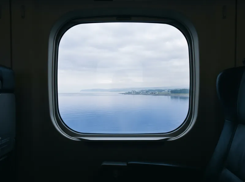 Calm Coast Through a Shinkansen Window — AI-generated photograph