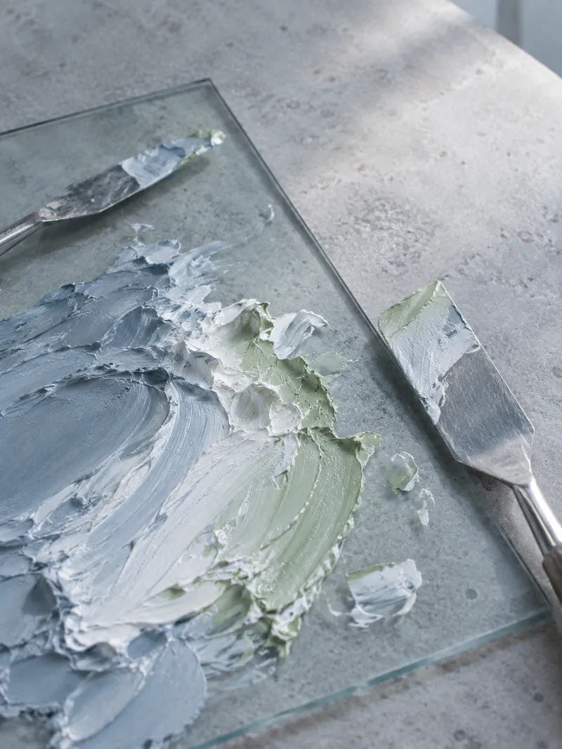 Two Knives Beside Mixed Blue Paint — AI-generated photograph