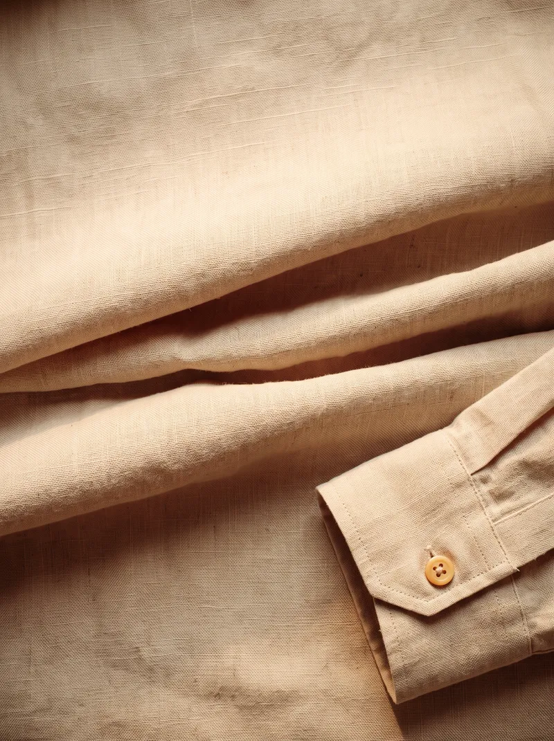 Folded Oatmeal Linen Shirt in Warm Even Light — AI-generated photograph
