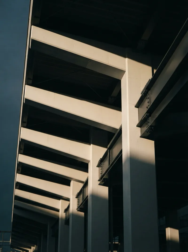 Station Canopy Beams in Low Raking Light — AI-generated photograph