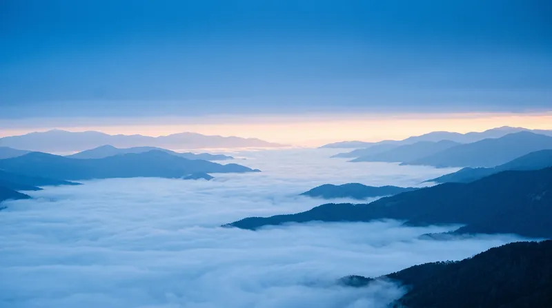 Mountain Ridges Above a Sea of Clouds at Dawn — AI-generated photograph