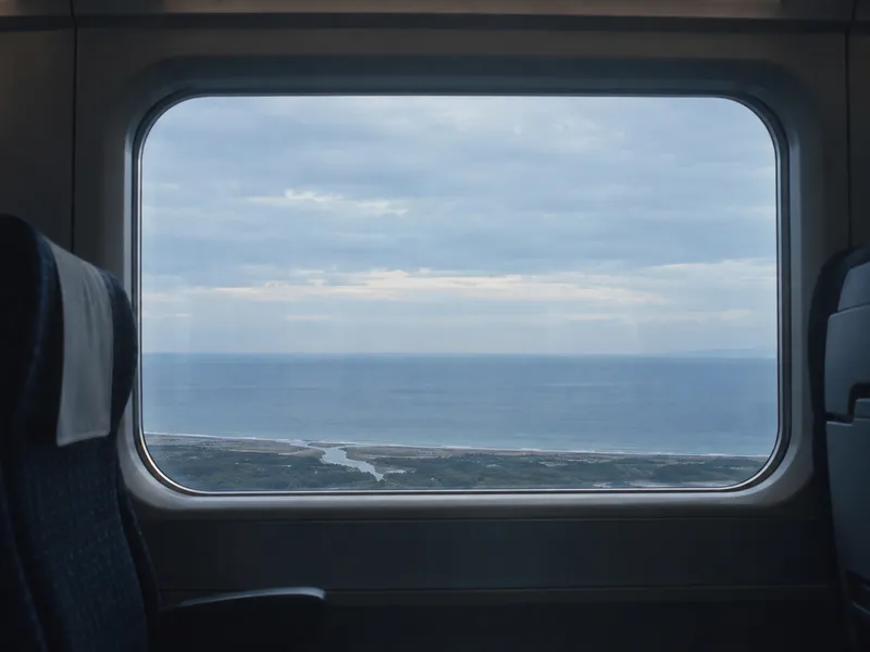 River Mouth Through a Train Window — AI-generated photograph