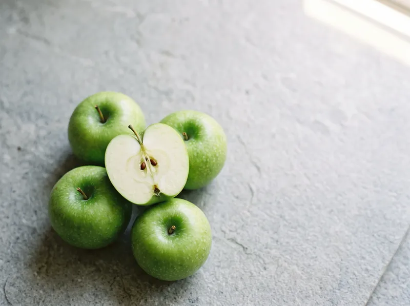 Overhead Green Apples on a Grey Stone Slab — AI-generated photograph