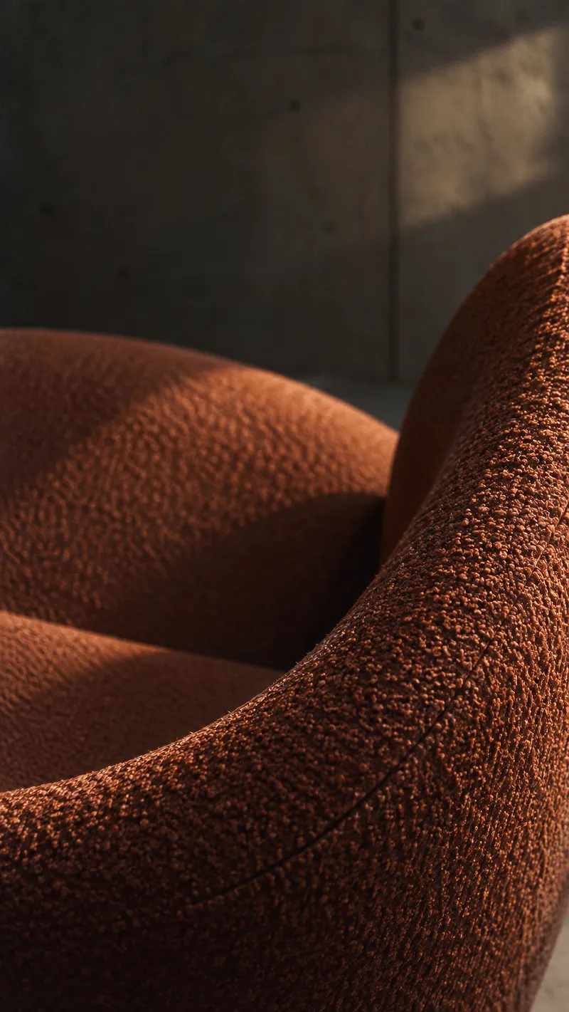 Boucle Chair Arm Above a Curved Seat — AI-generated photograph