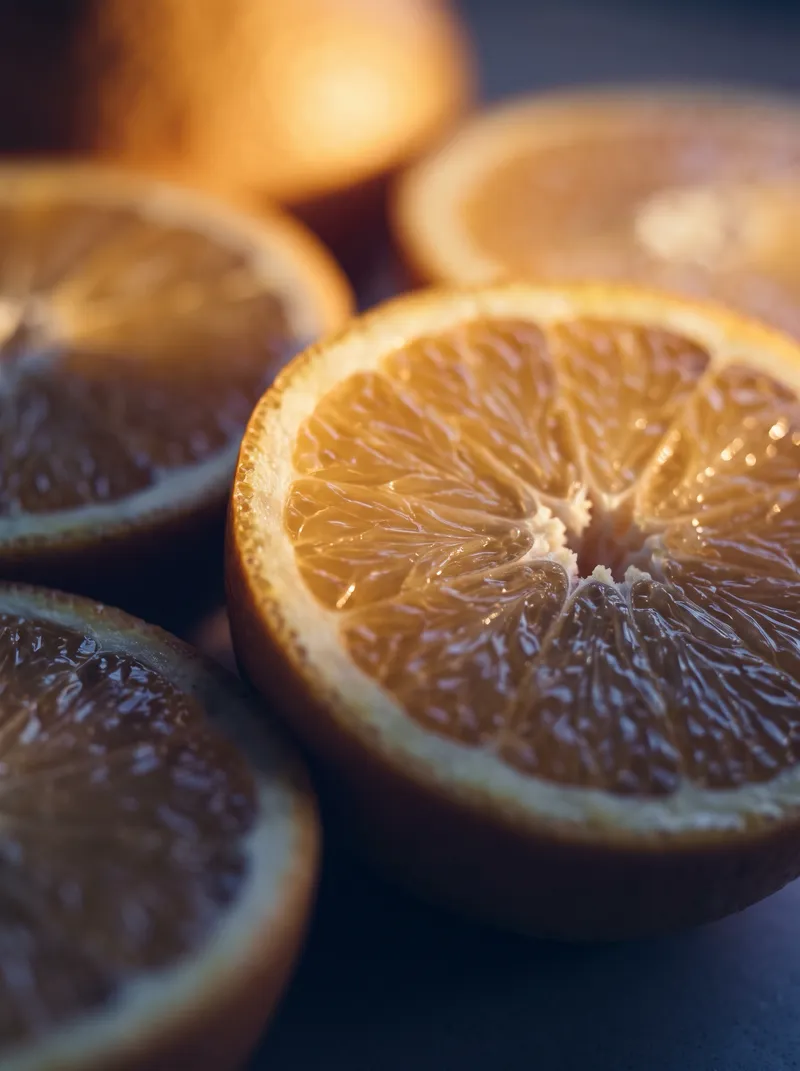 Backlit Halved Orange with Violet Shadows — AI-generated photograph