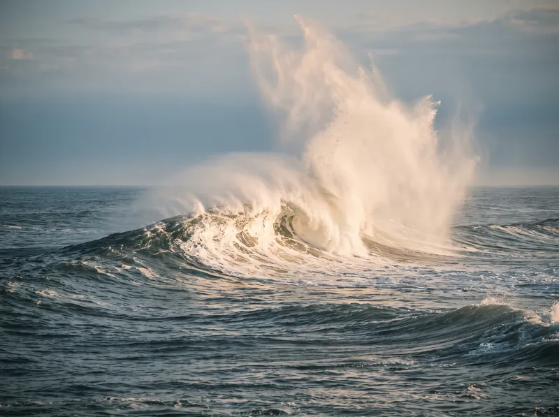 Backlit Breaking Wave and Amber Spray on a Summer Sea — AI-generated photograph