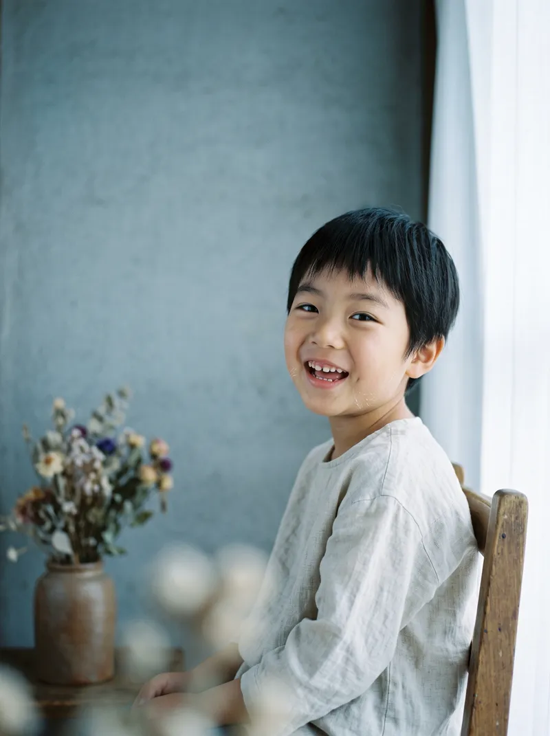 Smiling Child by an Overcast Window — AI-generated photograph