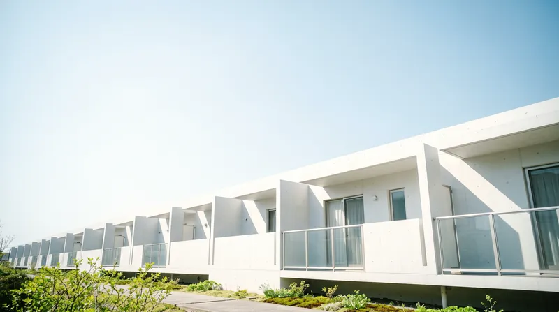 White Apartment Balconies Under a Pale Spring Sky — AI-generated photograph